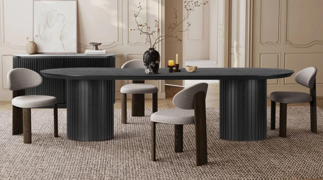 Modern black oval dining table with cushioned chairs in a stylish Australian home interior