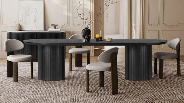 Modern black oval dining table with cushioned chairs in a stylish Australian home interior