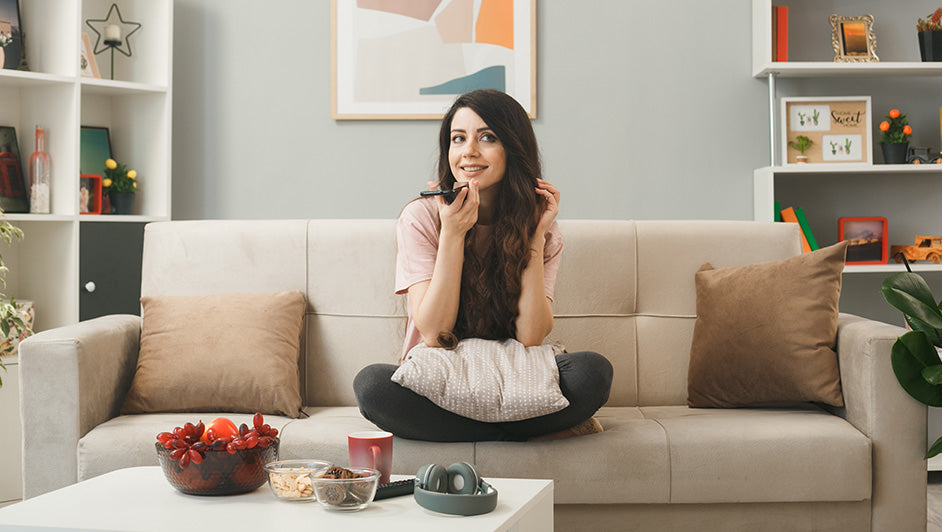 Woman relaxing on a beige sofa in a stylish small living room with modern décor